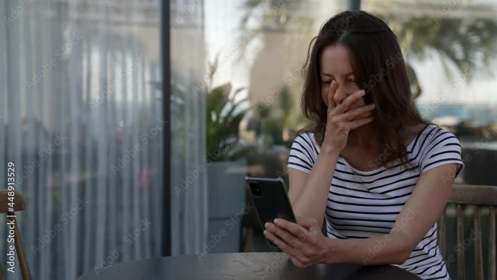 Portrait of a hippie woman relaxing with a phone video call in a restaurant on an outdoor veranda Portrait of a hippie woman relaxing with a phone video call in a restaurant on an outdoor veranda
