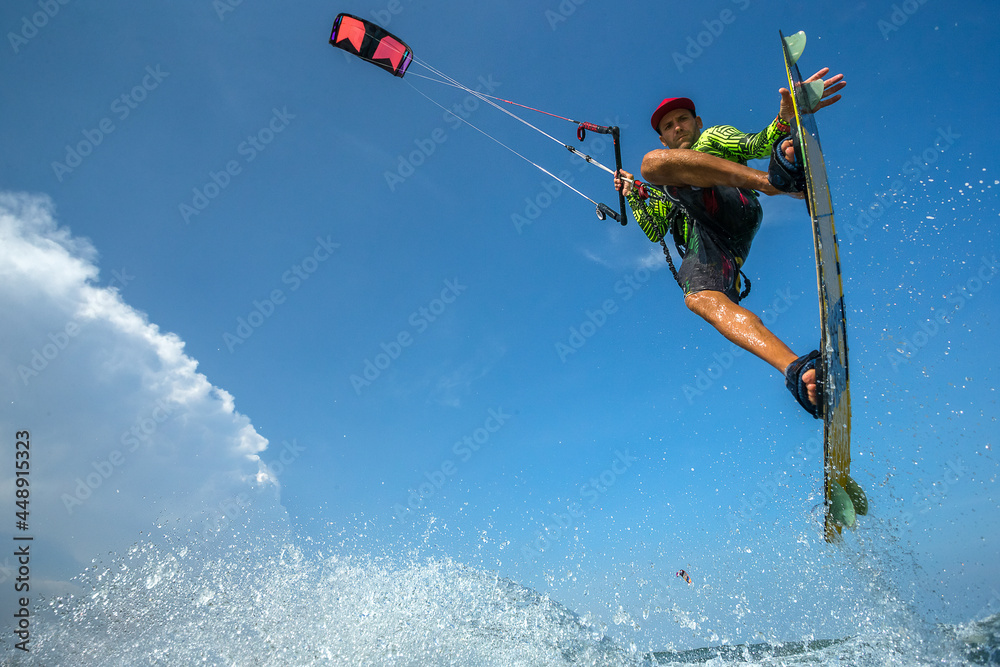 Naklejka premium A kite surfer rides the waves 