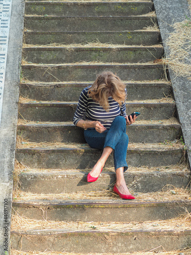 woman sitting on a the stairs in the park photo