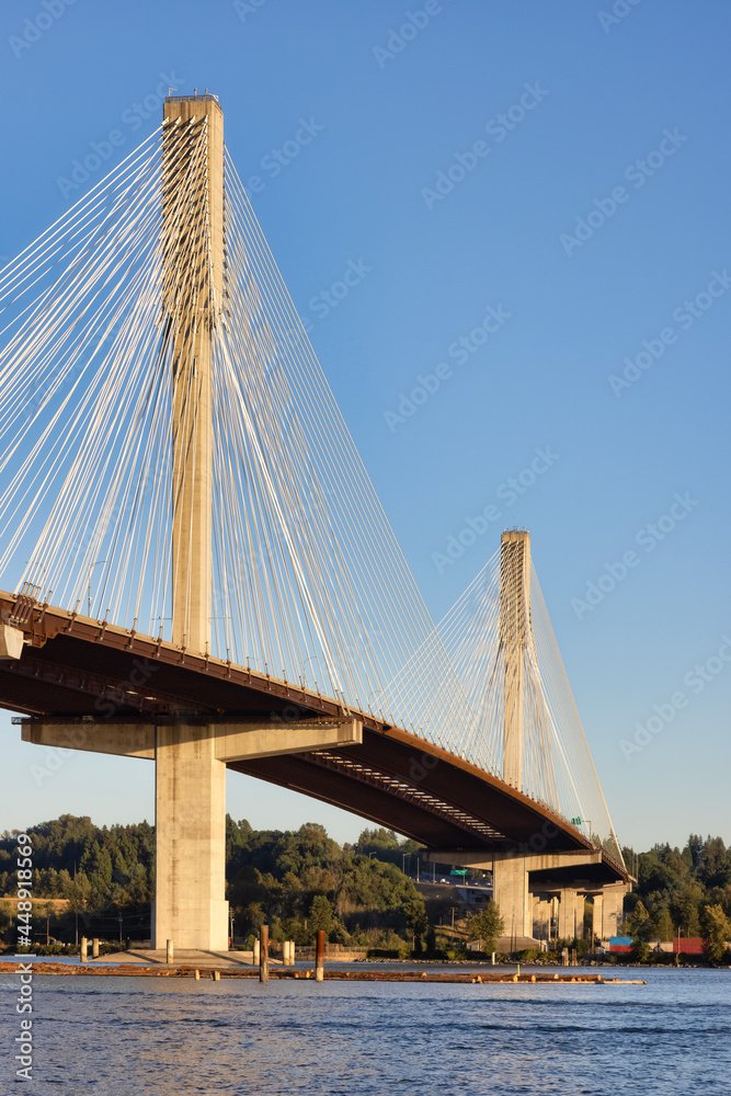 Naklejka premium Port Mann Bridge over the Fraser River. Sunny Summer Sunset. Port Coquitlam, Vancouver, British Columbia, Canada.
