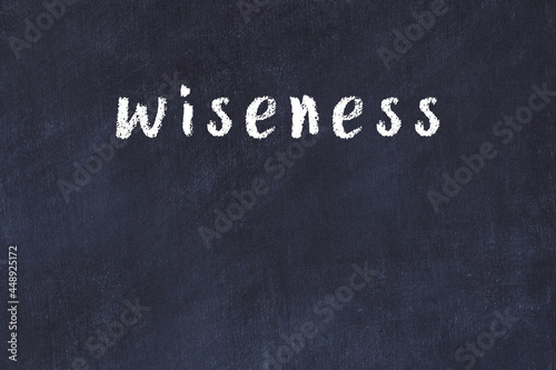 Photos College chalk desk with the word wiseness written on in