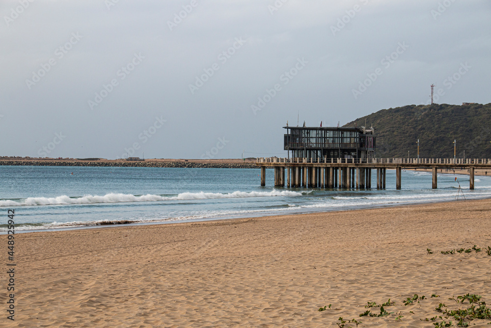 Empty Beach and Pier with Bluff in Background