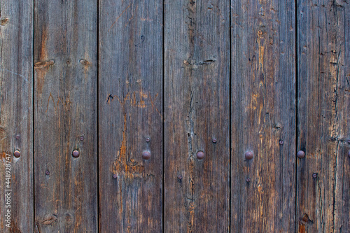 Old dark wooden planks. Old shabby wooden fence. Wooden background.