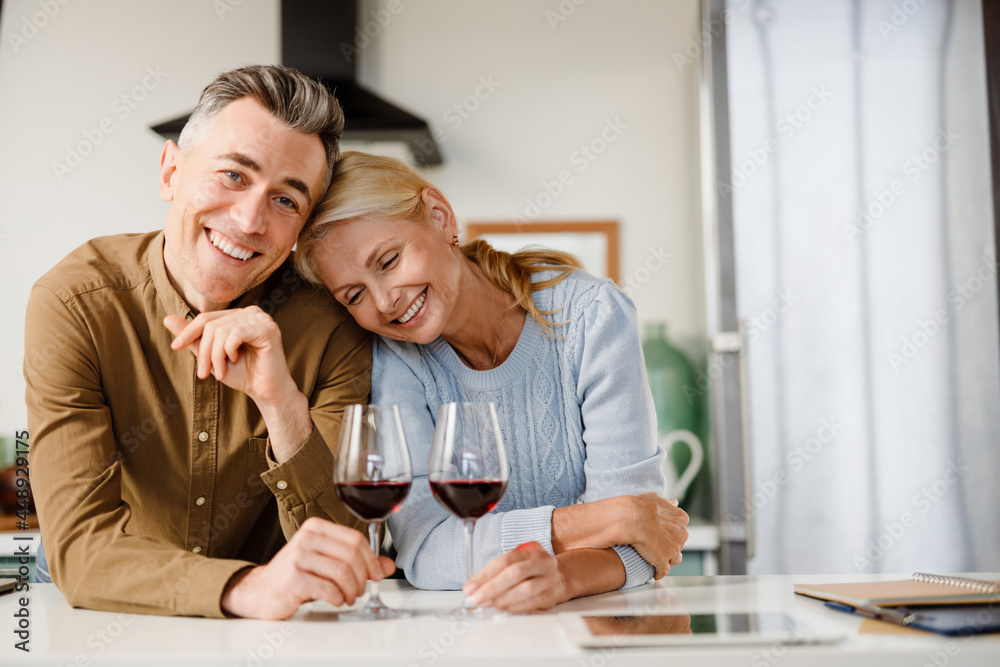 Smiling middle aged couple standing together Smiling middle aged couple standing together
