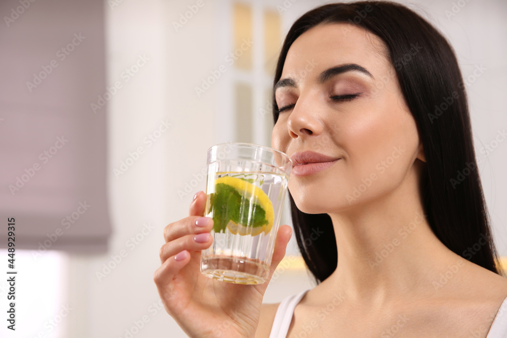 Young woman with glass of fresh lemonade at home Young woman with glass of fresh lemonade at home