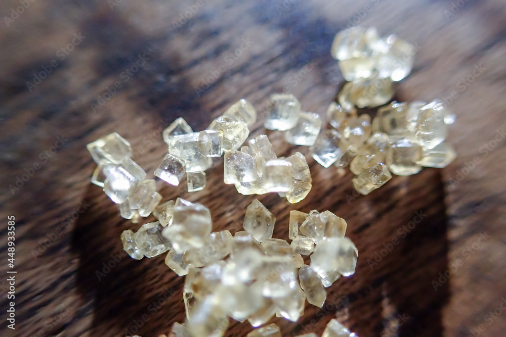 Macro selective focus. Sugar falling on a wooden table. There is space to enter text. Macro selective focus. Sugar falling on a wooden table. There is space to enter text.
