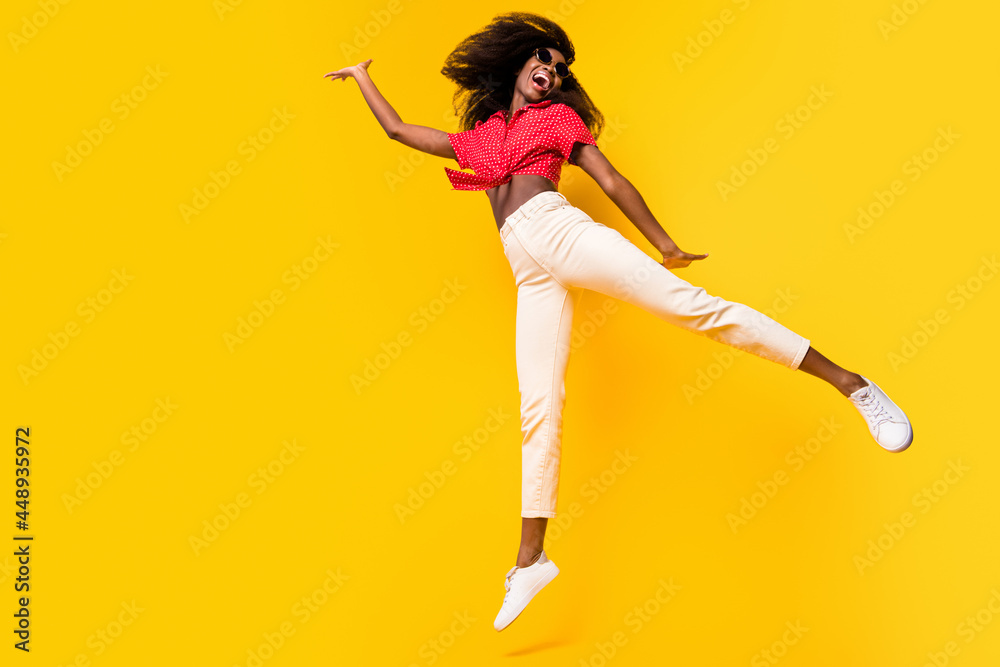 Full size profile photo of nice optimistic brunette lady jump wear red top eyewear isolated on yellow backgound