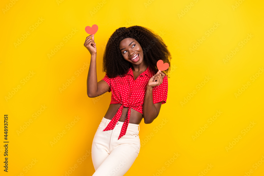 Photo of nice optimistic brown hair lady hold heart look empty space wear shirt isolated on yellow color background Photo of nice optimistic brown hair lady hold heart look empty space wear shirt isolated on yellow color background