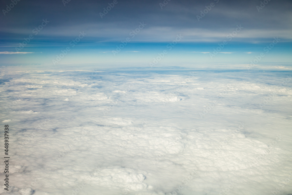 Clouds and sky as seen through window of an aircraft