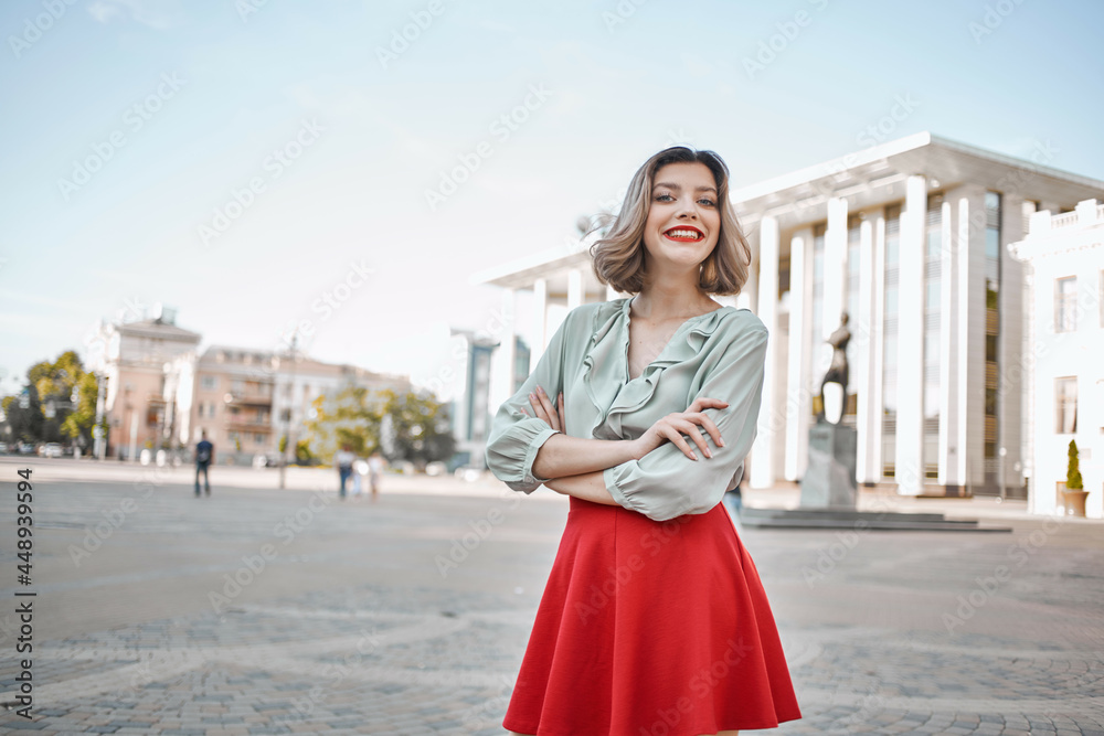 cute blonde girl with red lips outdoors in the city posing walk