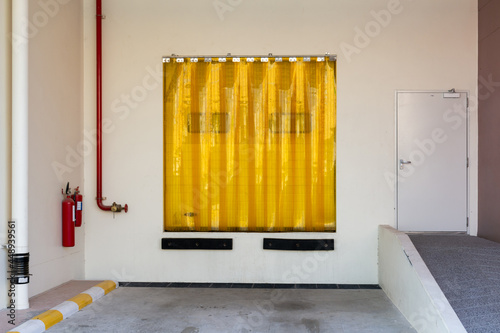 Wallpaper Mural Industry door entrance with Transparent yellow plastic strip curtain. Torontodigital.ca