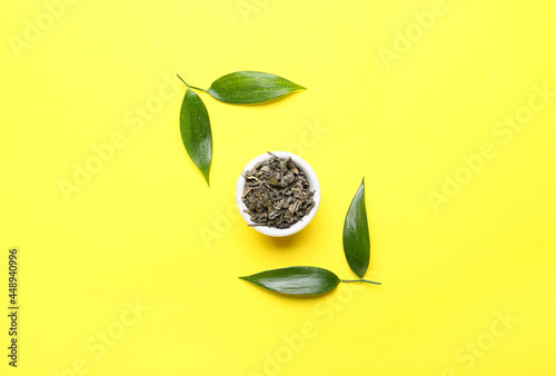 Bowl with dry tea and green...