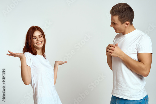 cheerful young couple in white t-shirts communication emotions lifestyle studio