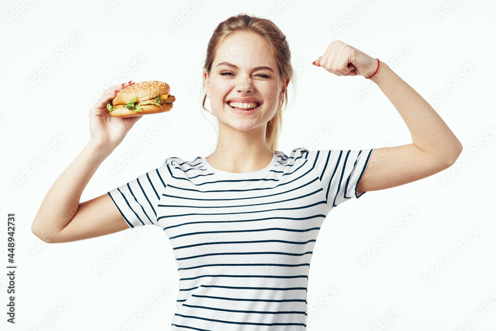 woman in striped t-shirt fast food snack junk food woman in striped t-shirt fast food snack junk food