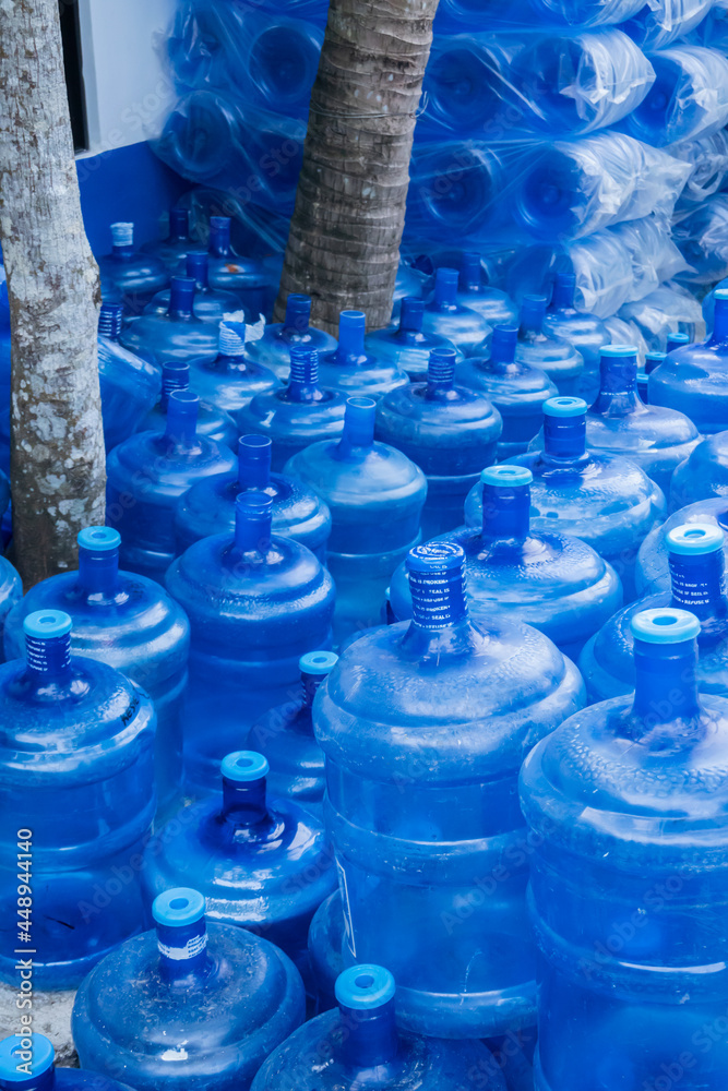 Water cooler bottles await refilling at a water refilling station in