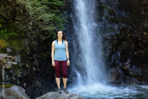 Adult Woman hiker at Norvan Falls and river stream in the natural canyon during the summer time. Canadian Nature Background. Lynn Valley, North Vancouver, British Columbia, Canada. photo