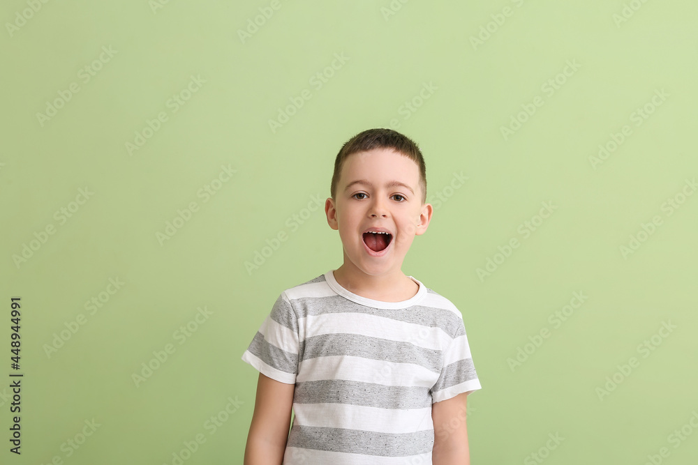 Little boy training pronounce letters on color background Little boy training pronounce letters on color background