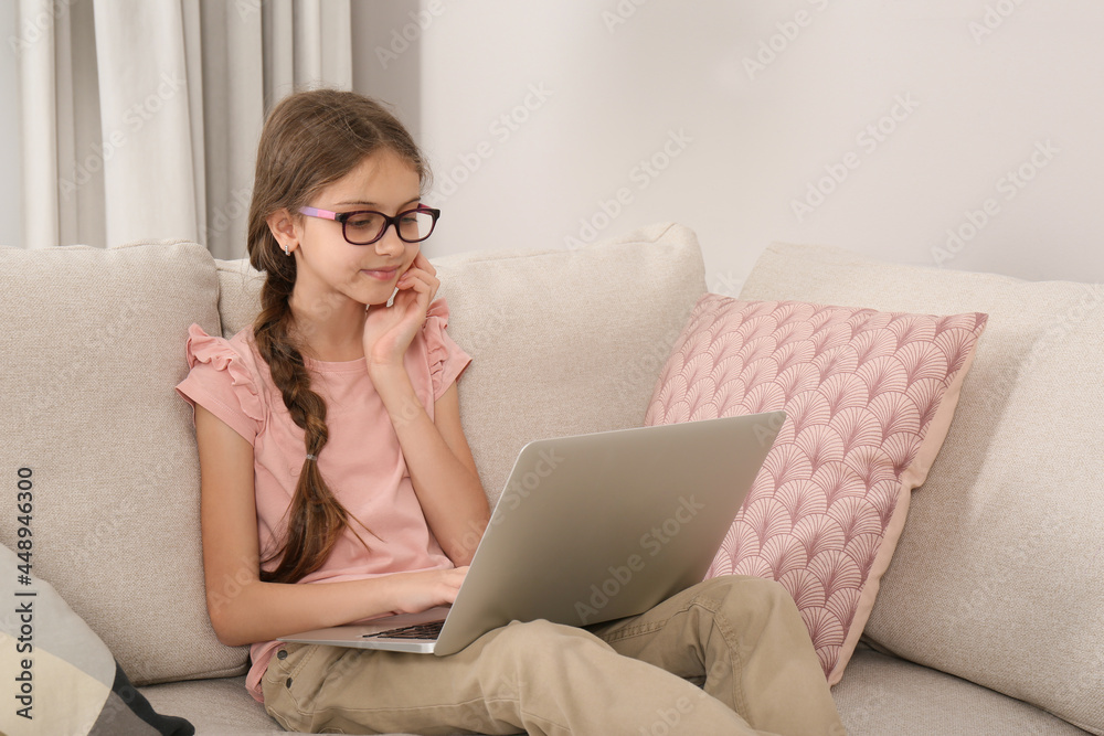 Girl with laptop on sofa at home Girl with laptop on sofa at home