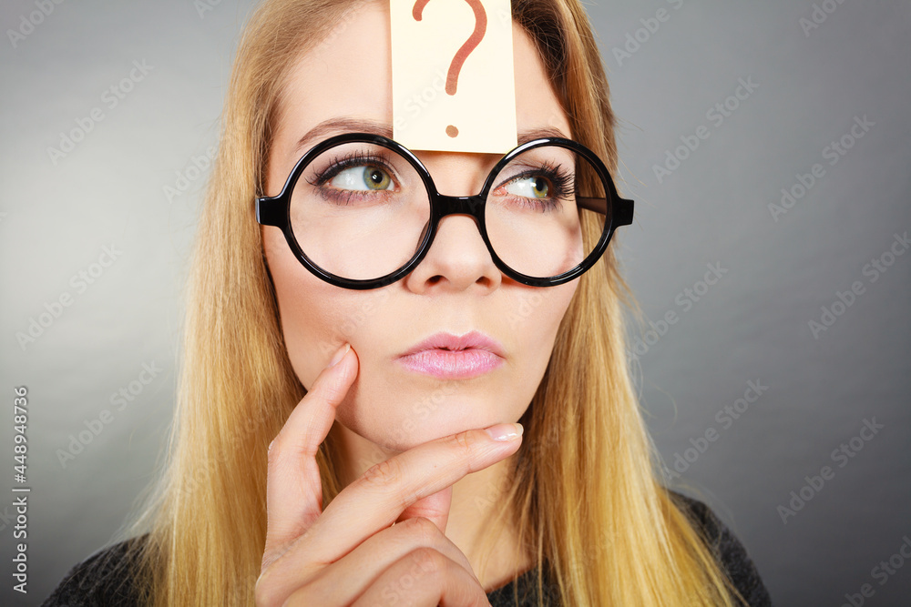 Woman having question mark on forehead thinking Woman having question mark on forehead thinking