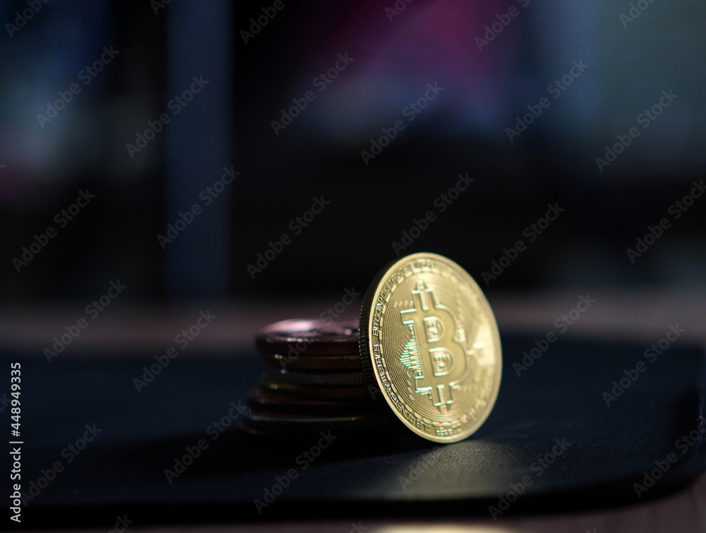Pile of golden shiny crypto coins abstract finance risk on dark room background wiht copy space