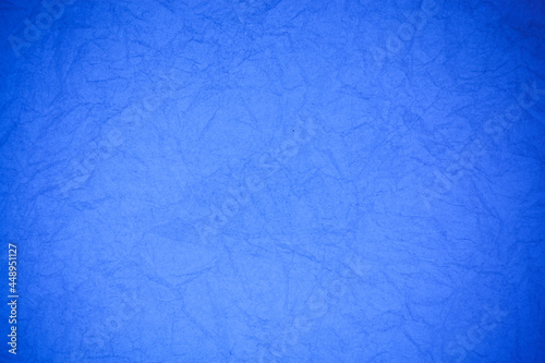 Crumpled vintage blue paper textured obsolete background.