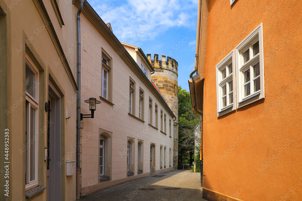 A narrow alley with tower of the former city wall Coburg - Germany