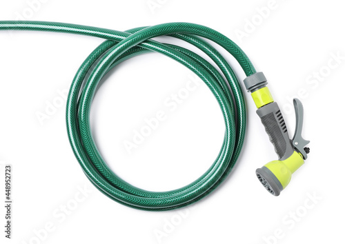 Green rubber watering hose with nozzle isolated on white, top view photo