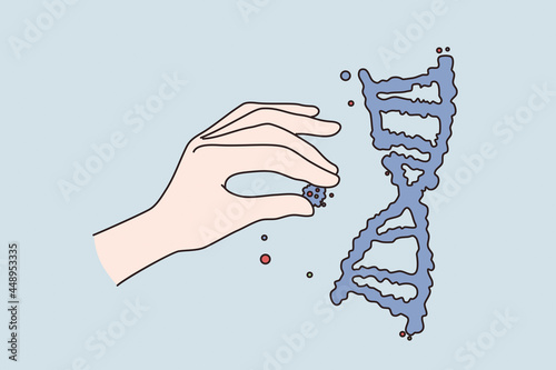 Generic engineering science research concept. Human hand holding putting cells to human dna structure ober blue background vector illustration  photo