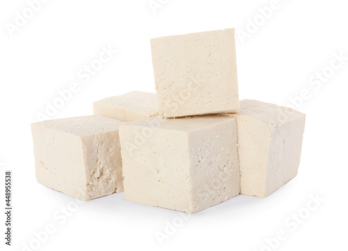 Cubes of delicious raw tofu on white background