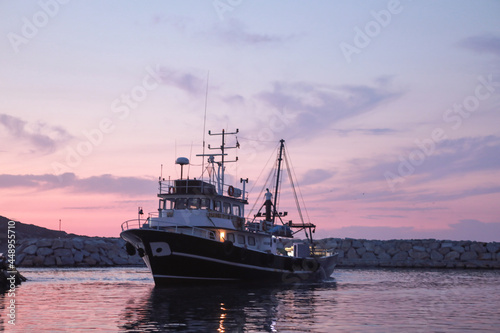 An evening on the Aegean coast and the fishing boat is ready for fishing.