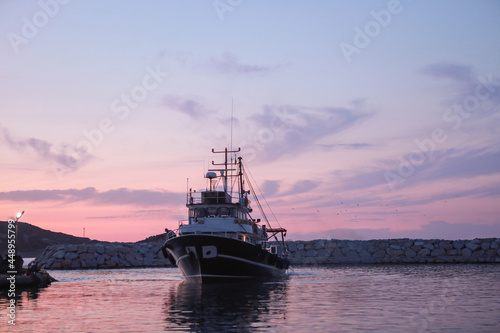 An evening on the Aegean coast and the fishing boat is ready for fishing.