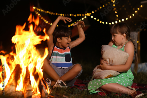 Little children near fire o...