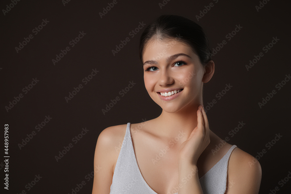 Portrait of pretty girl on brown background. Beautiful face with perfect smooth skin Portrait of pretty girl on brown background. Beautiful face with perfect smooth skin