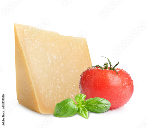 Delicious parmesan cheese, tomato and basil on white background