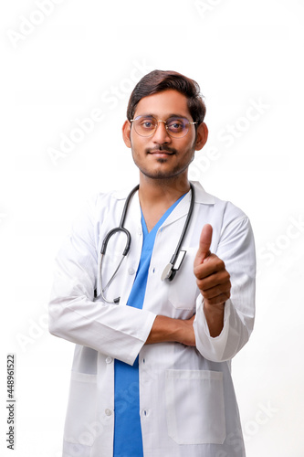 Doctor in a white coat with a stethoscope and showing thumbs up
