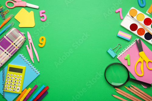 School supplies on green background with copy space. Back to school concept.