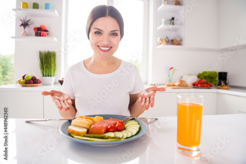 Photo of cheerful young attractive charming woman smile show hands meal dinner indoors inside home kitchen