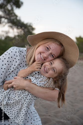 Little girl hugs mom tight