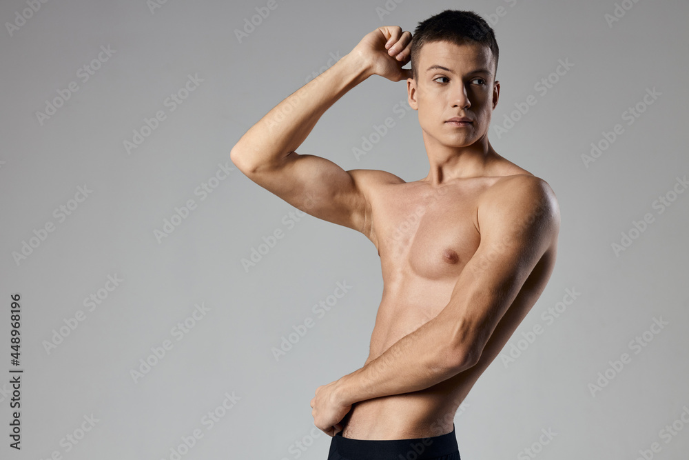 bodybuilder fitness man athlete on gray background cropped view Copy Space