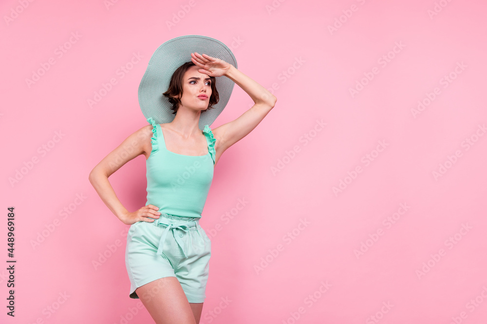 Photo of sweet unsure woman dressed turquoise tank-top far away empty space arm forehead isolated pink color background Photo of sweet unsure woman dressed turquoise tank-top far away empty space arm forehead isolated pink color background