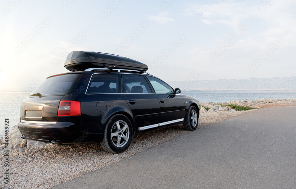 Travelers car on the seashore in the evening.