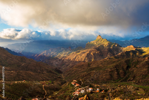 Obraz na płótnie Last light of the day hits Roque Bentayga, a natural rock pinnacle on Gran Canaria, Canary Islands, Spain. The rock is located within the volcanic caldera of Tejeda, in the heart of the island. w salonie