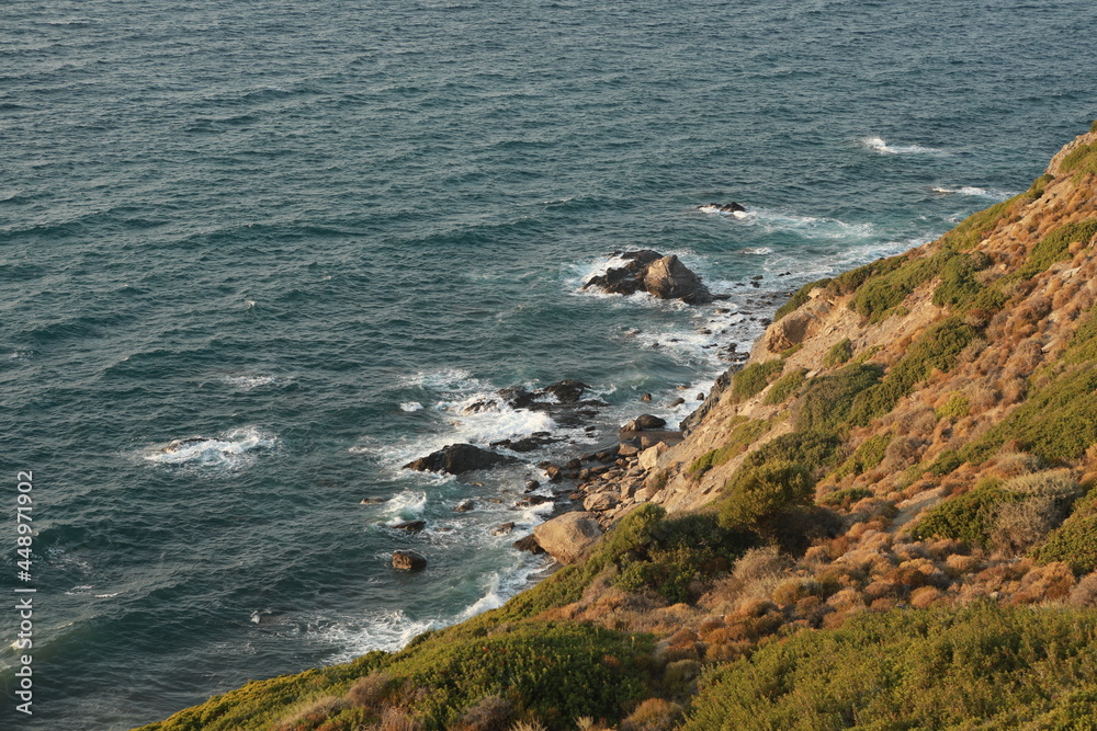 A sea view and mountain from the mediterranean. Great view with the waves hitting the beach.