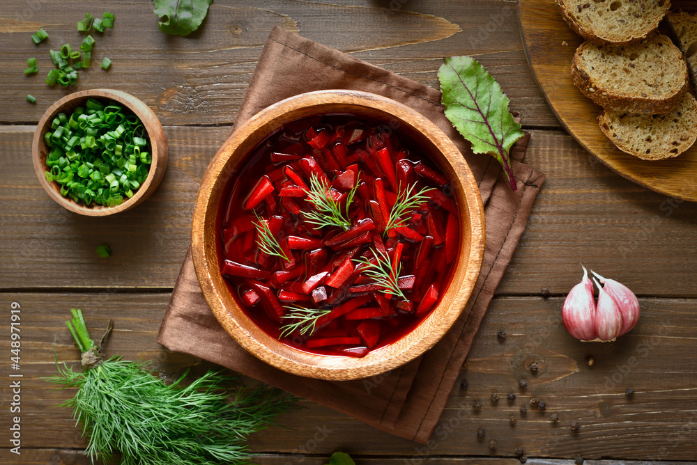 Borscht in bowl on wooden background