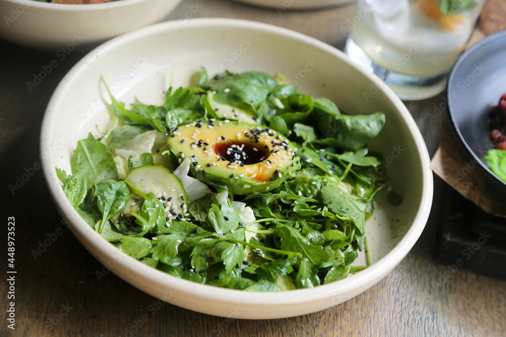 Healthy green salad with avocado and sesame dressing Healthy green salad with avocado and sesame dressing