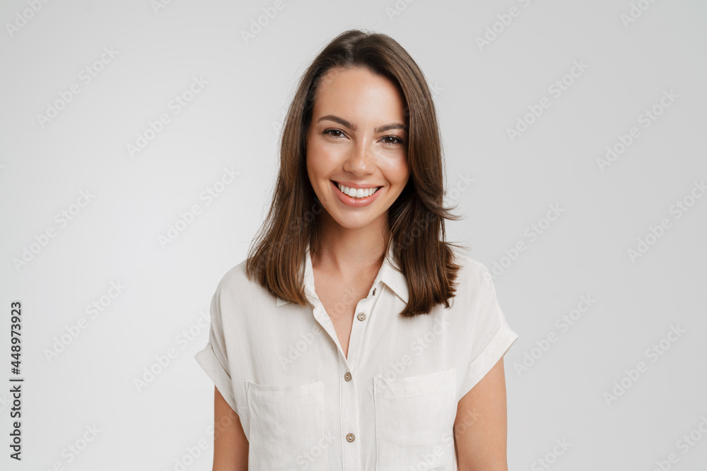 Young european woman in shirt smiling and looking at camera