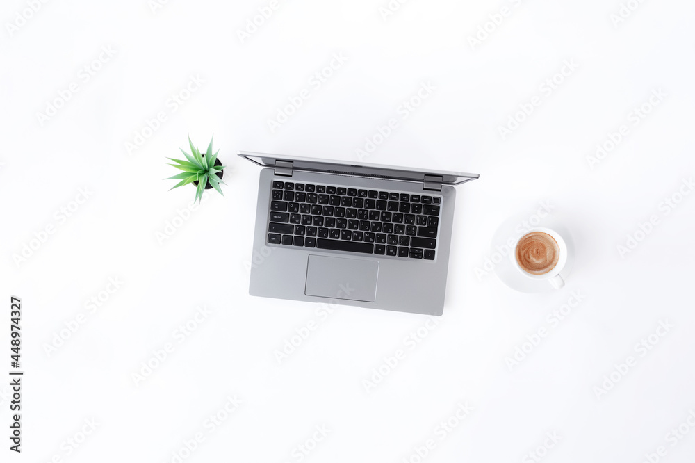 Laptop or notebook, cup of espresso coffee, green flowerpot on white background Laptop or notebook, cup of espresso coffee, green flowerpot on white background