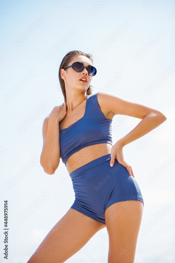 Portrait of a young beautiful woman in blue bikini