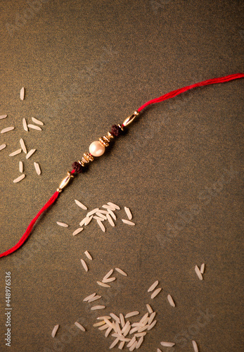 Photography Indian festival Raksha Bandhan background with an elegant Rakhi.
