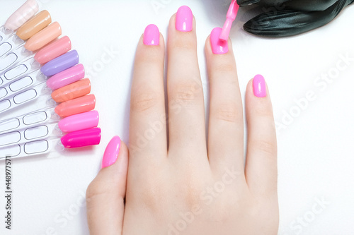 young woman gets a manicure in the salon.